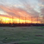Driving range barrier netting with wood support poles