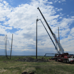 Steel support pole installation for driving range