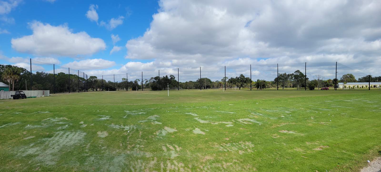 ST. PETERSBURG COUNTRY CLUB. Golf practice: nets, clubs, and balls on the green.
