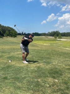 Golf Pro Teeing Off at Celebrity Golf Tournament in Tarpon Springs, Florida